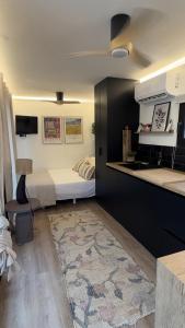 a small room with a bed and a kitchen at CasaNoa Boutique Guest Suites in Jávea