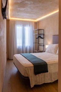 a bedroom with a large bed in front of a window at Artilles Suites in Peniscola