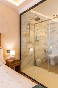 a bathroom with a shower with a toilet and a sink at Artilles Suites in Peniscola