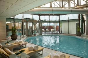 a large swimming pool in a building with a pool at InterContinental Toronto Centre by IHG in Toronto