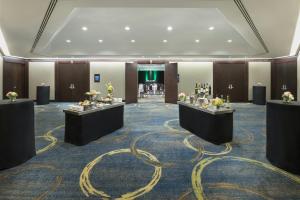 a hotel lobby with two tables with flowers on it at InterContinental Toronto Centre by IHG in Toronto +156 photos