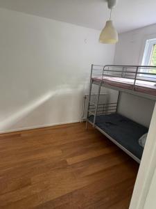 a room with two bunk beds and a wooden floor at Villa Timsfors i Markaryd in Markaryd