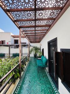 a balcony with a swimming pool and a pergola at Riad El Maâti in Rabat