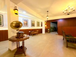 a lobby of a hospital with a table and chairs at Lion Resort in Polonnaruwa