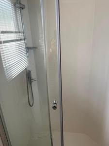 a shower with a glass door in a bathroom at Static 34 Newton Abbott Devon TQ126JR in Bickington +16 photos