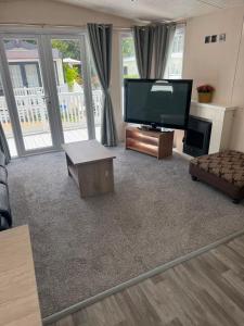 a living room with a large flat screen tv at Static 34 Newton Abbott Devon TQ126JR in Bickington