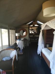 a train room with two beds and a mirror at Eco mara forest camp in Ololaimutiek