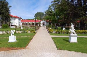 a garden with statues in front of a building at Resort Termas de Panimávida - Hotel & Spa in Panimávida