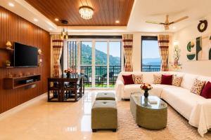 a living room with a couch and a table at Rizell Alexis in Shimla