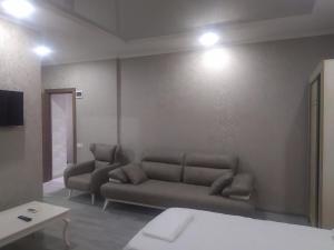 a living room with a couch and a table at Alped in Zestafoni