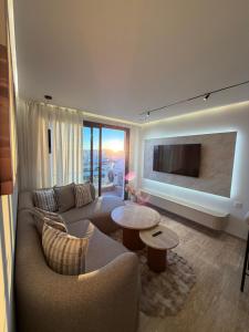 a living room with a couch and a tv at Triple Tower 23eme étage La vue 329 gare tgv & plage 3min in Tangier