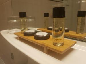 a bathroom counter with a bottle of soap and cookies at Le Patio De La Dordogne in Souillac +42 photos