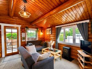 a living room with a couch and a tv at Snowdonia Escape in Trawsfynydd