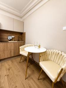 a dining room with a table and two chairs at Panorama Apartament in Poznań