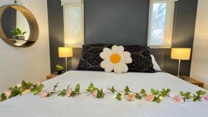 a bedroom with a bed with a flower on it at Nature Resort Villas - Villas with a View in Cowes