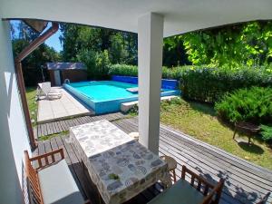 a patio with a pool and a table and chairs at CHALET Dom z basenem in Lutol Mokry