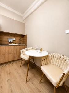 a dining room with a table and two chairs at Panorama Apartament in Poznań +13 photos