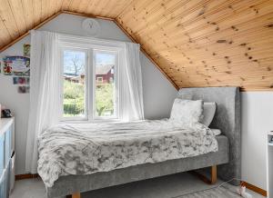 a bedroom with a bed and a window at Shared room in a quiet area in Kallinge