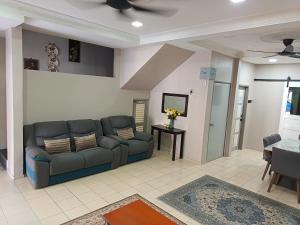 a living room with a couch and a table at Macchiato Homestay - Musslim Homestay in Klang