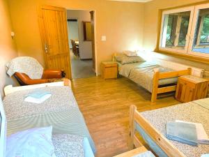 a small room with two beds and a window at Agroturystyka Różanka in Nowy Tomyśl +66 photos