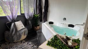 a bathroom with a bath tub with a turtle in it at Nature Resort Villas - Villas with a View in Cowes