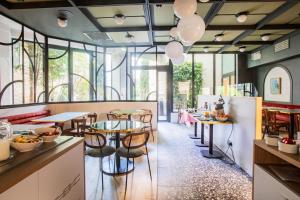 a restaurant with tables and chairs and windows at Best Western Crequi Lyon Part Dieu in Lyon