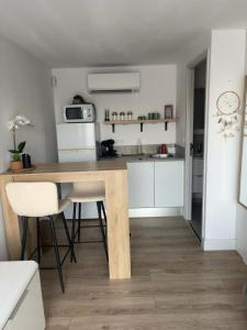 a kitchen with a wooden table and white cabinets at À Casarella di Lisa in Vescovato