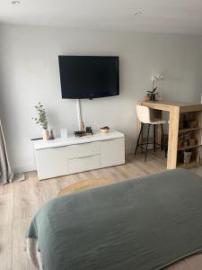 a living room with a flat screen tv on a wall at À Casarella di Lisa in Vescovato