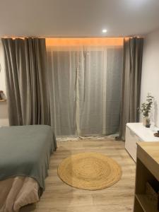 a bedroom with a bed and a large window at À Casarella di Lisa in Vescovato