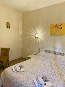a bedroom with a bed with two towels on it at La Bohème - Chambres d'hôtes in Midoun