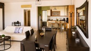 a living room with a bed and a dining room at Among the pines in Katakolo