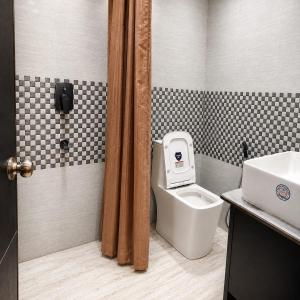 a bathroom with a toilet and a sink at Narayan Palace- Luxury Homestay in Varanasi