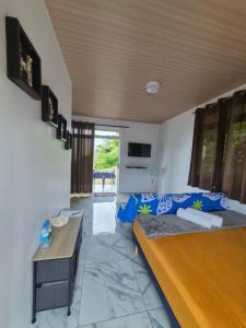 a living room with two beds and a couch at Fare Hanihau in Uturoa