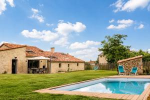 a backyard with a swimming pool and a house at La borderie de Beauregard in Treize-Vents