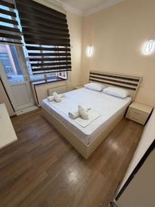 a bedroom with a bed with two towels on it at Oscar Hotel Guba in Quba