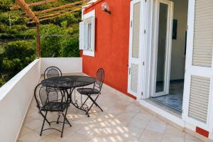 a patio with a table and chairs on a balcony at Maridea - La Marina in Ponza