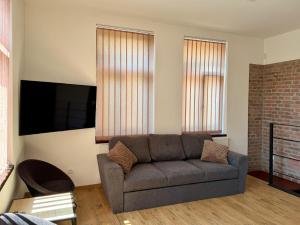 a living room with a couch and a flat screen tv at Apartmán Palza Jablonec in Jablonec nad Nisou
