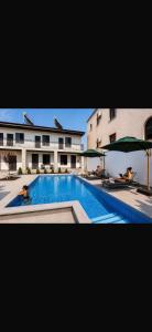 a large swimming pool in front of a building at Barseghyans Villa in Nor-Kesariya