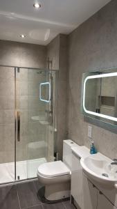 a bathroom with a shower and a toilet and a sink at Edinburgh West Residences in Edinburgh