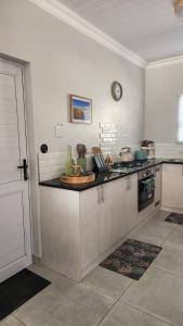 a kitchen with a stove and a counter top at Ocean Whisper Strandfontein in Strandfontein
