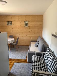 a living room with a couch and a table at Apartmani Zelena jela in Šljivovica