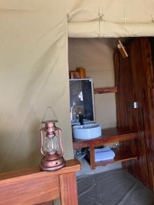 a bathroom with a sink and a mirror at Oloibormut in Sekenani