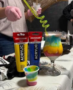 a table topped with a glass of colorful drink at Art Studio BN - Create Your Own Fluid ART Masterpiece! in Bistriţa