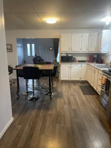 a kitchen with a table in the middle of it at Condo DidiPier in La Tuque