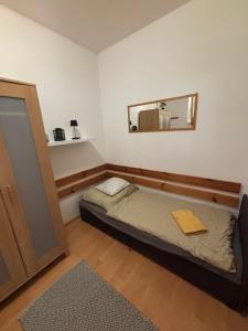 a small room with a bed and a mirror at Apartmán PT Donovaly in Donovaly