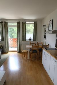 a kitchen and living room with a table and a dining room at Apartmán PT Donovaly in Donovaly