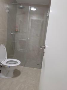 a bathroom with a toilet and a shower with a glass door at Koresh 10 - Emilia suite in Jerusalem +9 photos