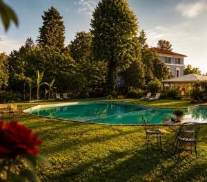a swimming pool in the yard of a house at Resort Dei Limoni Tower Inn in Lucca