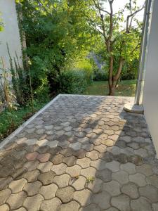 a stone walkway in front of a house at Apartma Sonček in Šentjur +4 photos