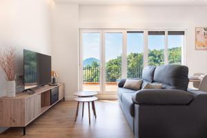 a living room with a couch and a tv at The Rooftop Apartments in Basauri
